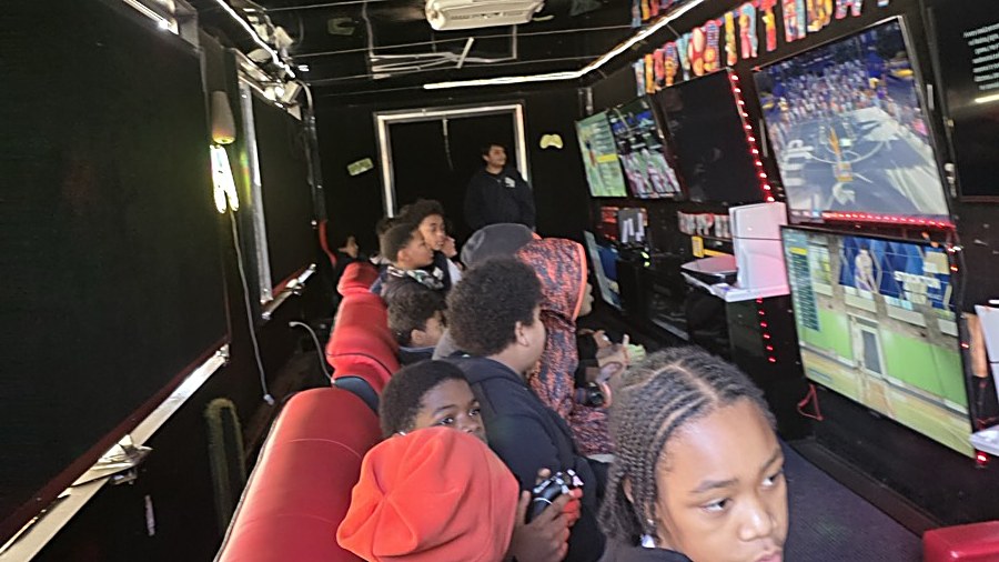 Kids playing video games inside the Party Game Truck