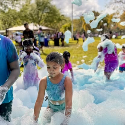 Kids playing in a foam pit at an outdoor birthday party