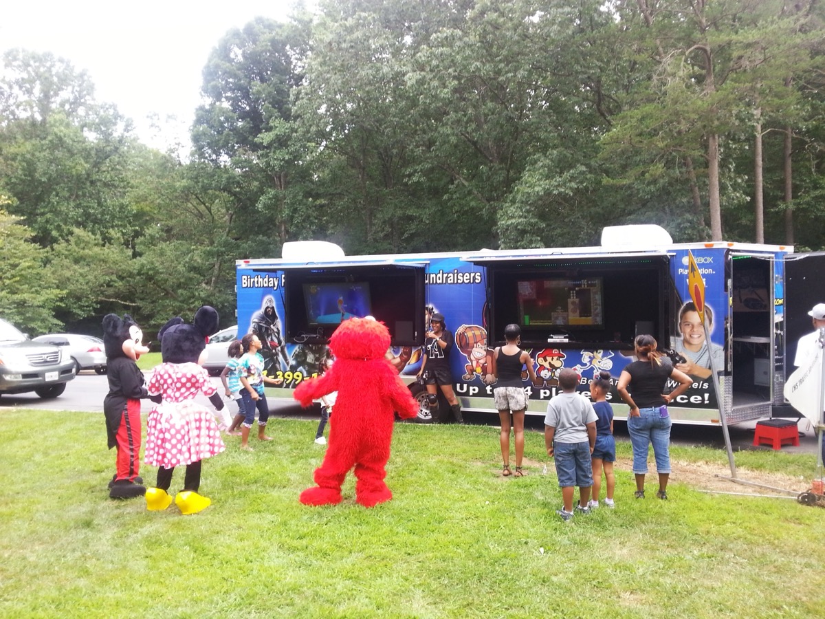 Mickey Mouse, Minnie Mouse and Elmo characters at Party Game Truck event
