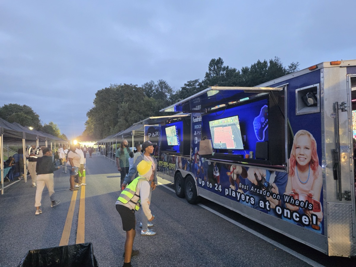 Party Game Truck at large outdoor festival at dusk