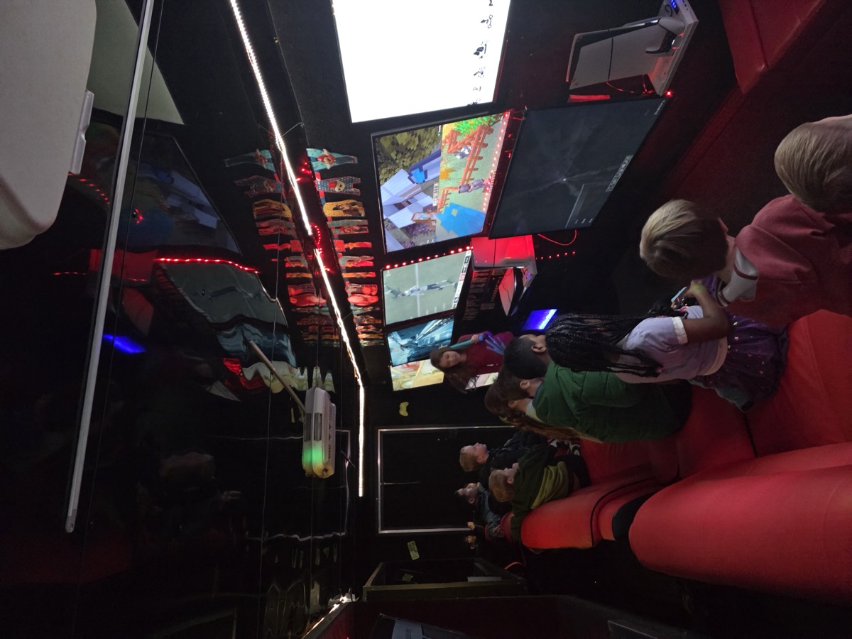 Kids gaming inside Party Game Truck with multiple screens